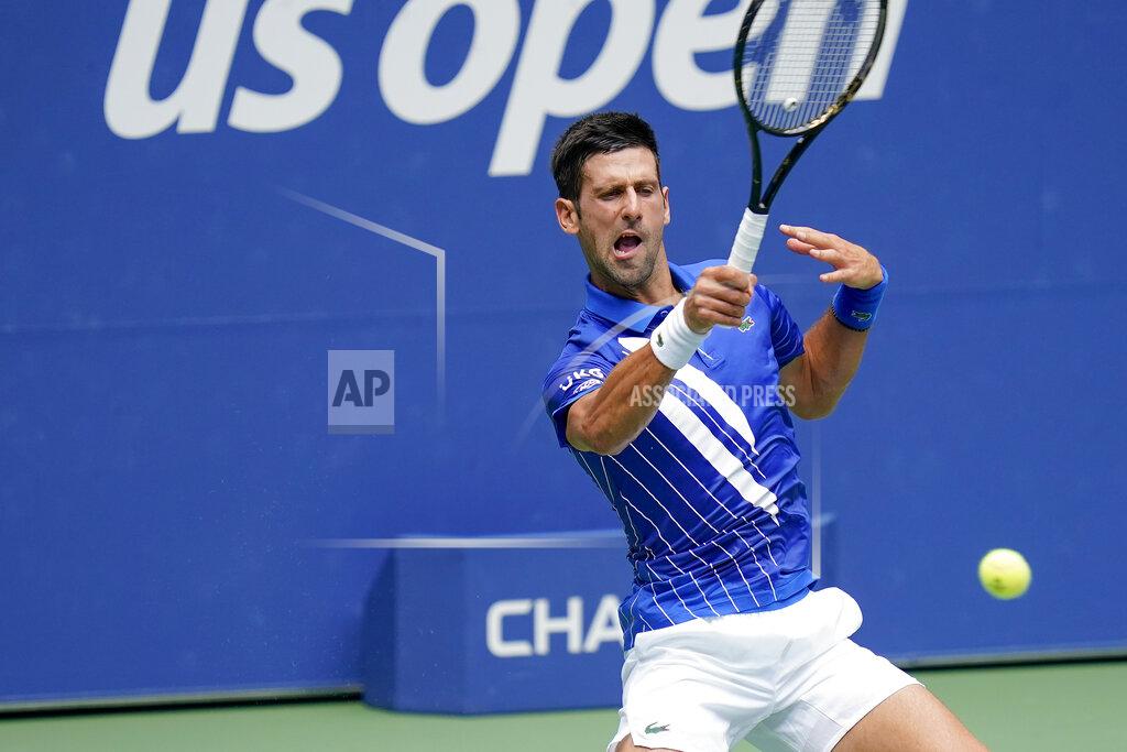 Seth Wenig Novak Djokovic, of Serbia, returns a shot to Kyle Edmund, of Great Britain, during the second round of the US Open tennis championships, Wednesday, Sept. 2, 2020, in New York. (AP Photo/Seth Wenig)