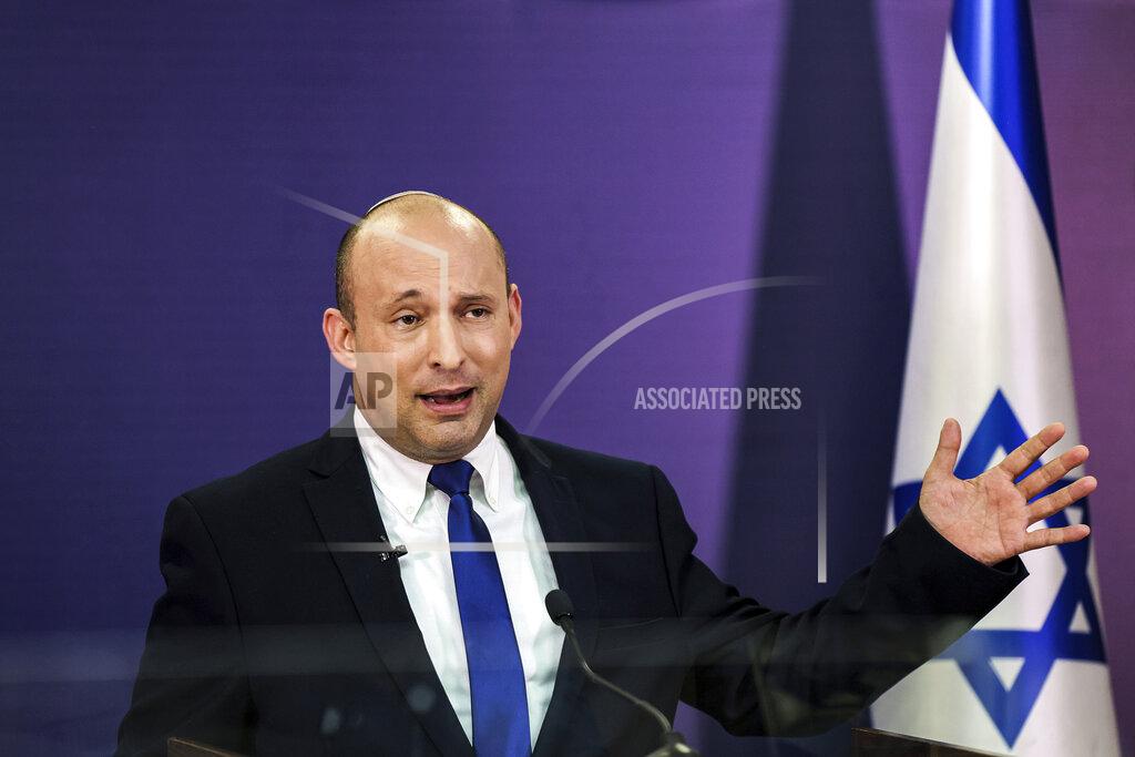 Menahem Kahana FILE - In this June 6, 2021, file photo, Naftali Bennett, Israeli parliament member from the Yamina party, gives a statement at the Knesset, Israel's parliament, in Jerusalem. If all goes according to plan, Israel will swear in a new government on Sunday, June 13, putting an end to Prime Minister Benjamin Netanyahu’s record 12-year rule and a political crisis that led to four elections in less than two years. The next government, which will be led by the ultranationalist Bennett, has vowed to chart a new course aimed at healing the country’s divisions and restoring a sense of normalcy. (Menahem Kahana/Pool via AP, File)
