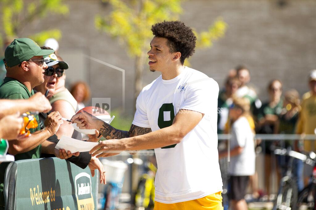 Samantha Madar Green Bay Packers wide receiver Christian Watson (9) signs his autograph for fans before NFL football training camp on Thursday, July 28, 2022, at Ray Nitschke Field in Ashwaubenon, Wis. (Samantha Madar/The Post-Crescent via AP)