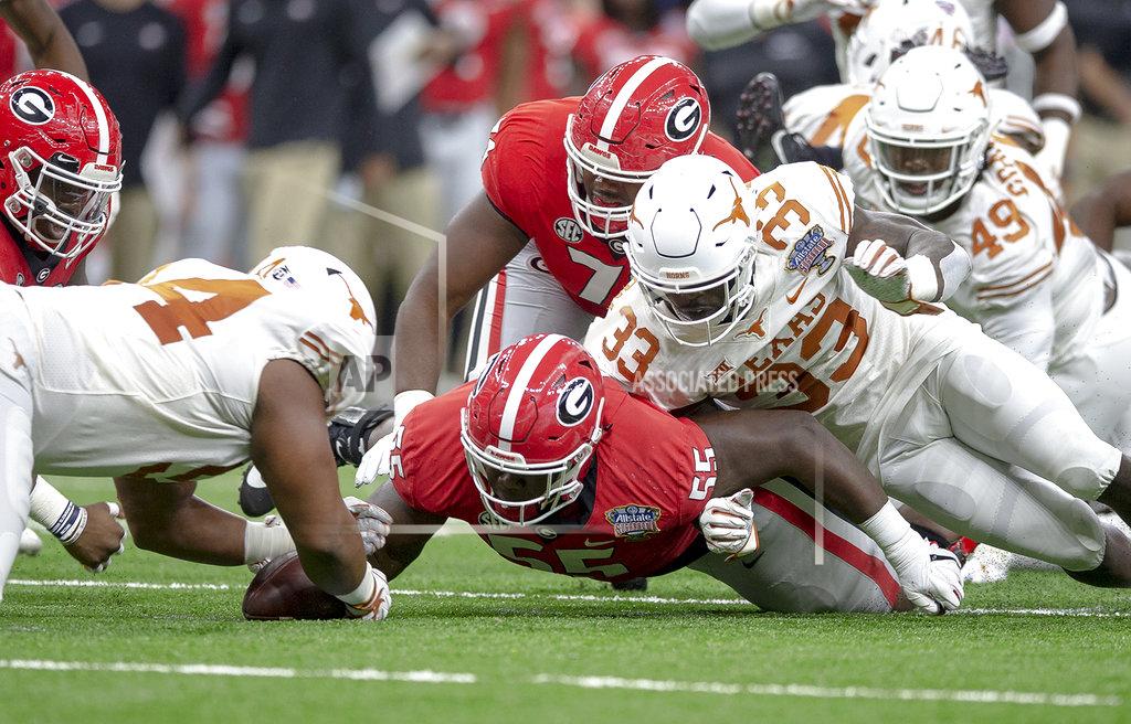 Nick Wagner Texas defensive lineman Gerald Wilbon (94) recovers a fumble by Georgia running back D'Andre Swift during the first half of the Sugar Bowl NCAA college football game Tuesday, Jan. 1, 2019, in New Orleans. (Nick Wagner/Austin American-Statesman via AP)