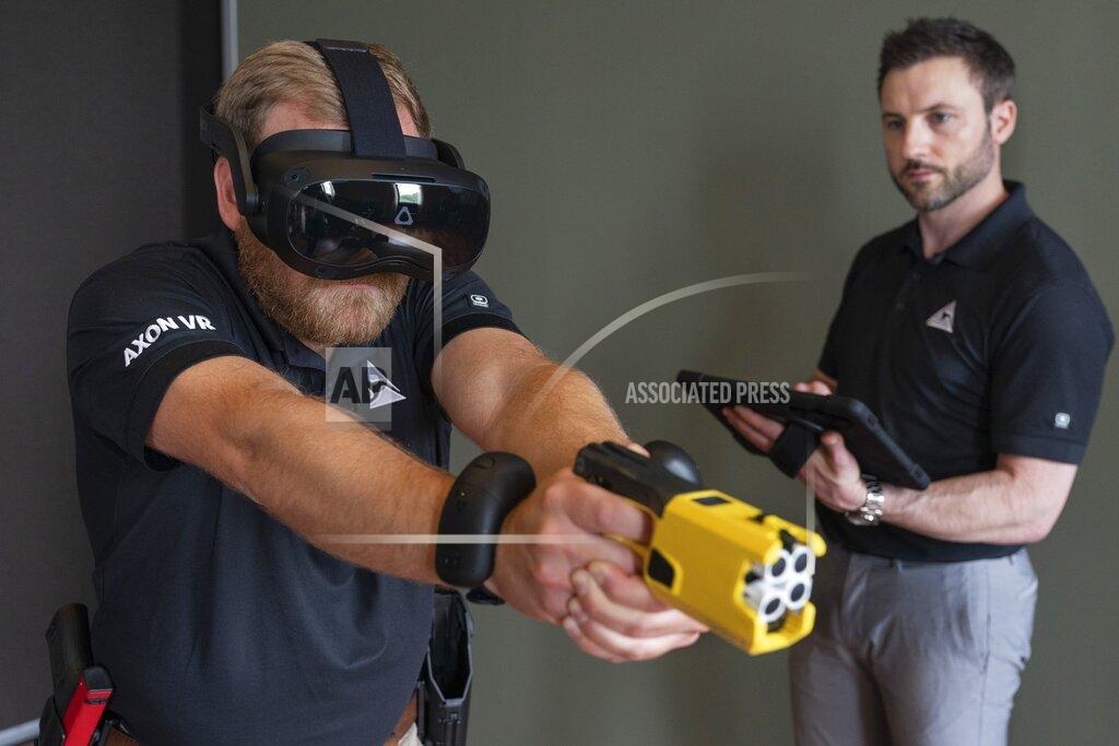 Jacquelyn Martin VR equipment and a version of the TASER 7 that utilizes VR technology for training, is demonstrated, Thursday, May 12, 2022, in Washington. Axon, the company that is best known for developing the Taser, is expanding virtual reality and immersive training in an effort to encourage police officers across the U.S. to more regularly train with less-than-lethal weapons. (AP Photo/Jacquelyn Martin)