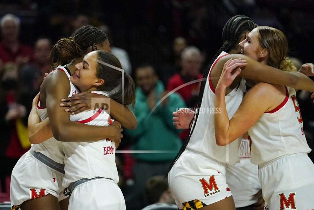 Julio Cortez Maryland guard Diamond Miller, left, hugs guard Katie Benzan, second from left, as forward Angel Reese, second from right, hugs forward Chloe Bibby as they get subbed for teammates late in the second half of a college basketball game against Florida Gulf Coast in the second round of the NCAA tournament, Sunday, March 20, 2022, in College Park, Md. Maryland won 89-65. (AP Photo/Julio Cortez)