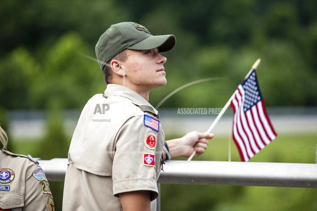 Sholten Singer Area residents arrive to show their respect before the funeral procession for Medal of Honor recipient Hershel "Woody" Williams passes by on Saturday, July 2, 2022, in Teays Valley, W.Va. (Sholten Singer/The Herald-Dispatch via AP)