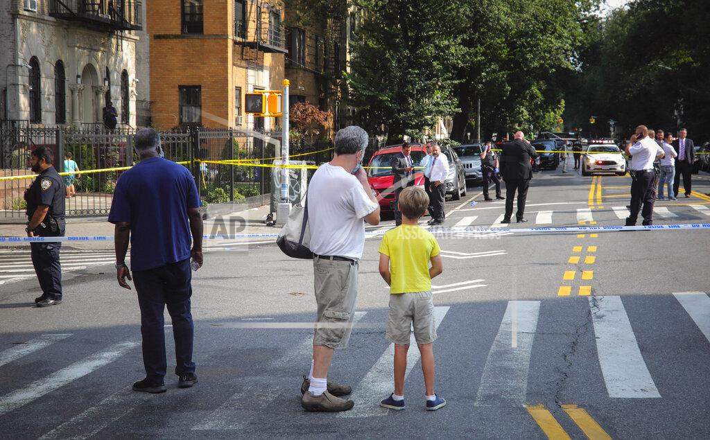 Bebeto Matthews FILE - Bystanders watch as police investigate the scene of a multiple shooting near Brooklyn's Prospect Park, Wednesday Aug. 19, 2020, in New York. Police report an 18-year-old male died from gunshot wounds to the chest and arms and a 33-year-old male with a gunshot wound to the abdomen is in stable condition. Police recorded 280 killings through Aug. 23, up from 208 during the same period last year. (AP Photo/Bebeto Matthews)