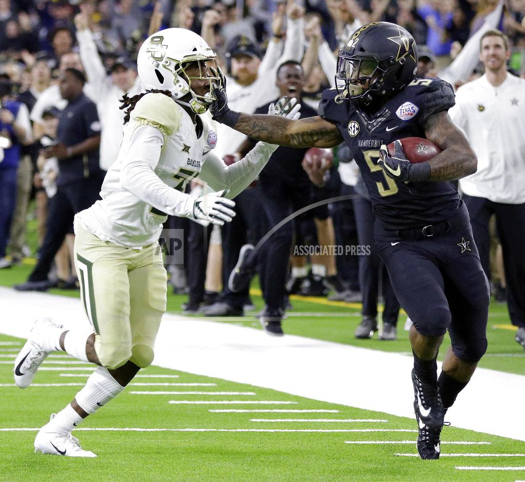 Michael Wyke Vanderbilt running back Ke'Shawn Vaughn (5) stiff-arms Baylor cornerback Harrison Hand (31) near the end zone during the second half of the Texas Bowl NCAA college football game, Thursday, Dec. 27, 2018, in Houston. (AP Photo/Michael Wyke)