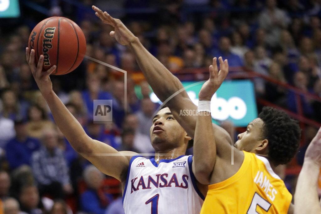 Orlin Wagner Kansas guard Devon Dotson (1) gets past Tennessee guard Josiah-Jordan James (5) for a basket during the first half of an NCAA college basketball game in Lawrence, Kan., Saturday, Jan. 25, 2020. (AP Photo/Orlin Wagner)
