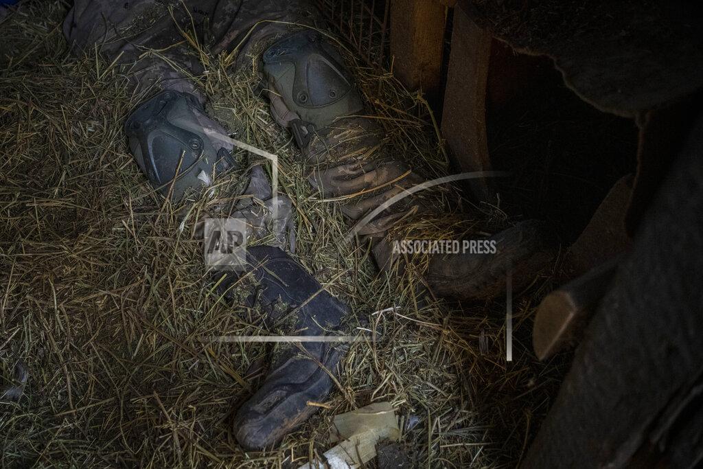 Bernat Armangue The body of a Russian soldier lies inside a henhouse in Vilkhivka, outskirts of Kharkiv, eastern Ukraine, Friday, May 20, 2022. (AP Photo/Bernat Armangue)