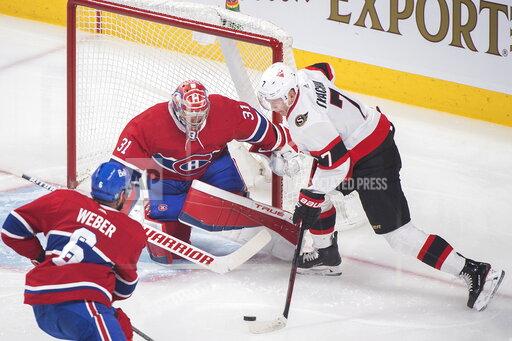 Graham Hughes Ottawa Senators' Brady Tkachuk (7) scores against Montreal Canadiens goaltender Carey Price as Canadiens' Shea Weber defends during first-period NHL hockey game action in Montreal, Saturday, April 3, 2021. (Graham Hughes/The Canadian Press via AP)