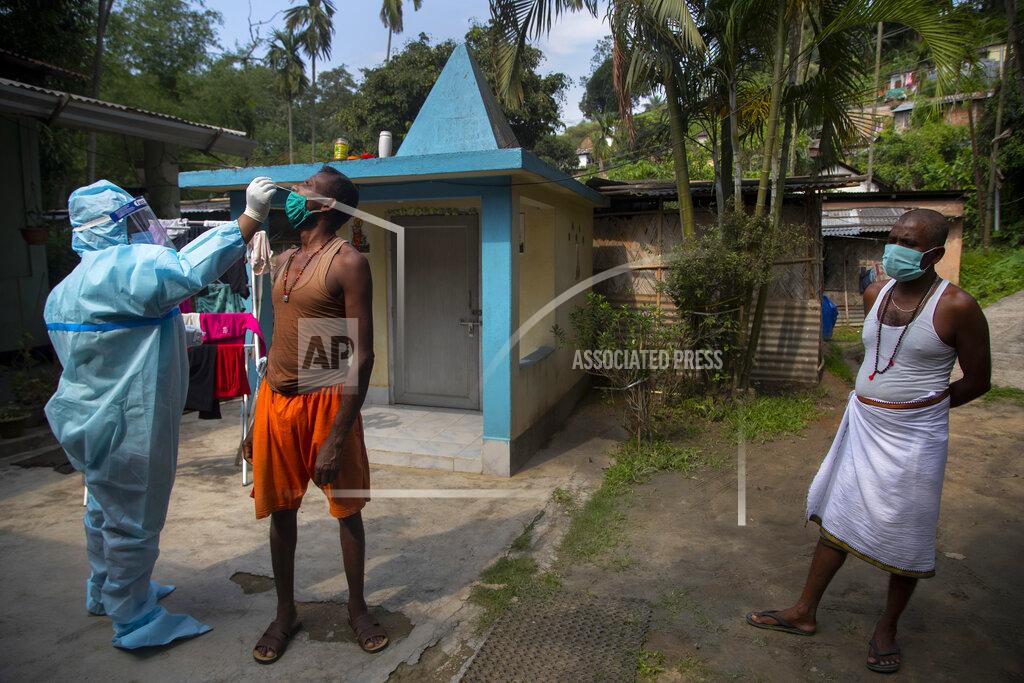 Anupam Nath A heath worker in protective suit takes nasal swab sample of a man to test for COVID-19 in Gauhati, India, Friday, May 21, 2021. India's confirmed coronavirus cases and deaths remained below record levels in the last 24 hours, but authorities are worried about fungal infection that attacks those with weak immune systems. (AP Photo/Anupam Nath)