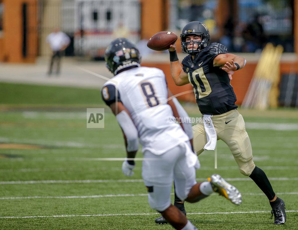 Nell Redmond Wake Forest quarterback Sam Hartman, right, throws a touchdown pass against Towson defensive back Monty Fenner in the first half of a NCAA college football game in Winston-Salem, N.C., Saturday, Sept. 8, 2018. (AP Photo/Nell Redmond)