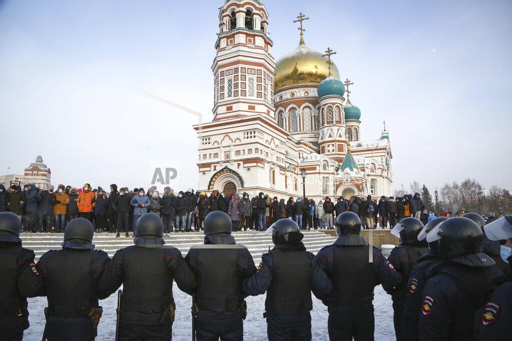 Uncredited Police stand guard during a protest against the jailing of opposition leader Alexei Navalny in Siberian city of Omsk, Russia, Saturday, Jan. 23, 2021. Russian police on Saturday arrested hundreds of protesters who took to the streets in temperatures as low as minus-50 C (minus-58 F) to demand the release of Alexei Navalny, the country's top opposition figure. Navalny, President Vladimir Putin's most prominent foe, was arrested on Jan. 17 when he returned to Moscow from Germany, where he had spent five months recovering from a severe nerve-agent poisoning that he blames on the Kremlin. (AP Photo)