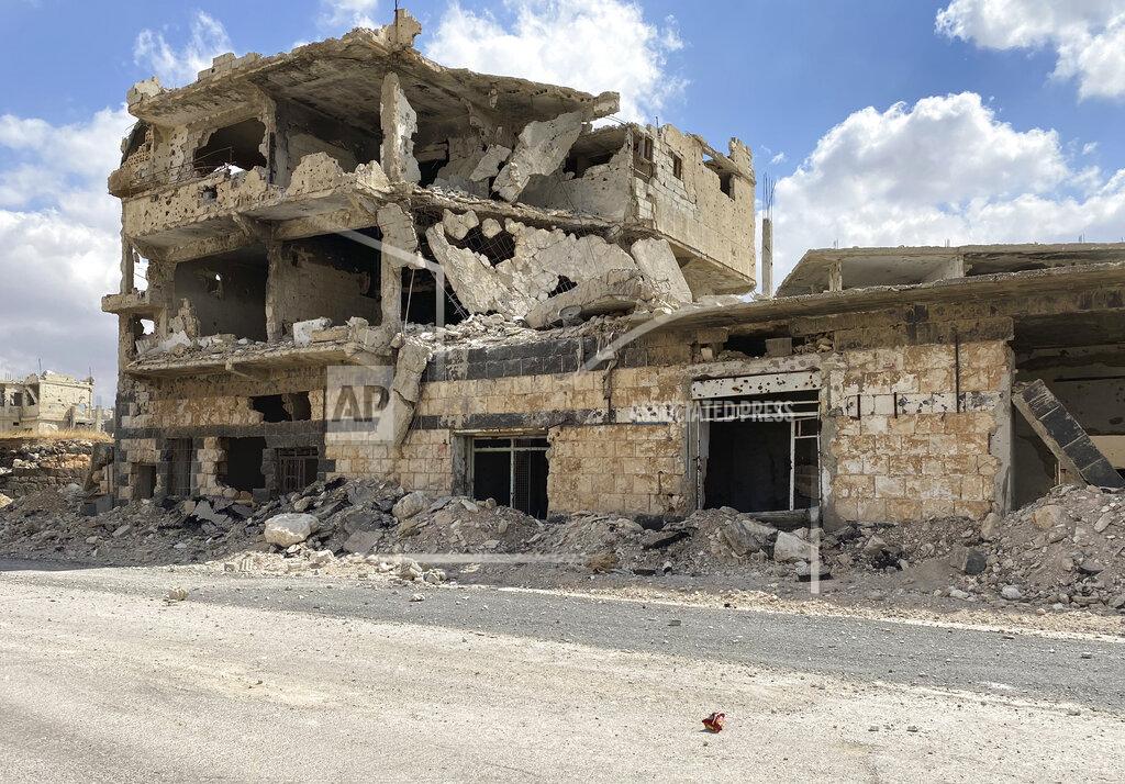 Uncredited A building damaged by Syrian government forces following clashes with rebel fighters is seen in the southern city of Daraa, Syria, Sunday, Sept 12, 2021. A Russian-negotiated deal went into effect last week to end a government siege and intense fighting in the city of Daraa and with rebel fighters holed up Daraa al-Balad forcing some of them to go to the rebel-held north and others to surrender their weapons in return for amnesty. (AP Photo)