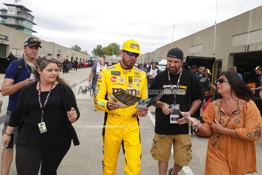 Michael Conroy NASCAR Xfinity Series driver Kyle Busch signs autographs as he makes his way through the garage ares during the NASCAR Xfinity auto racing practice at Indianapolis Motor Speedway, Friday, Sept. 6, 2019 in Indianapolis. (AP Photo/Michael Conroy)