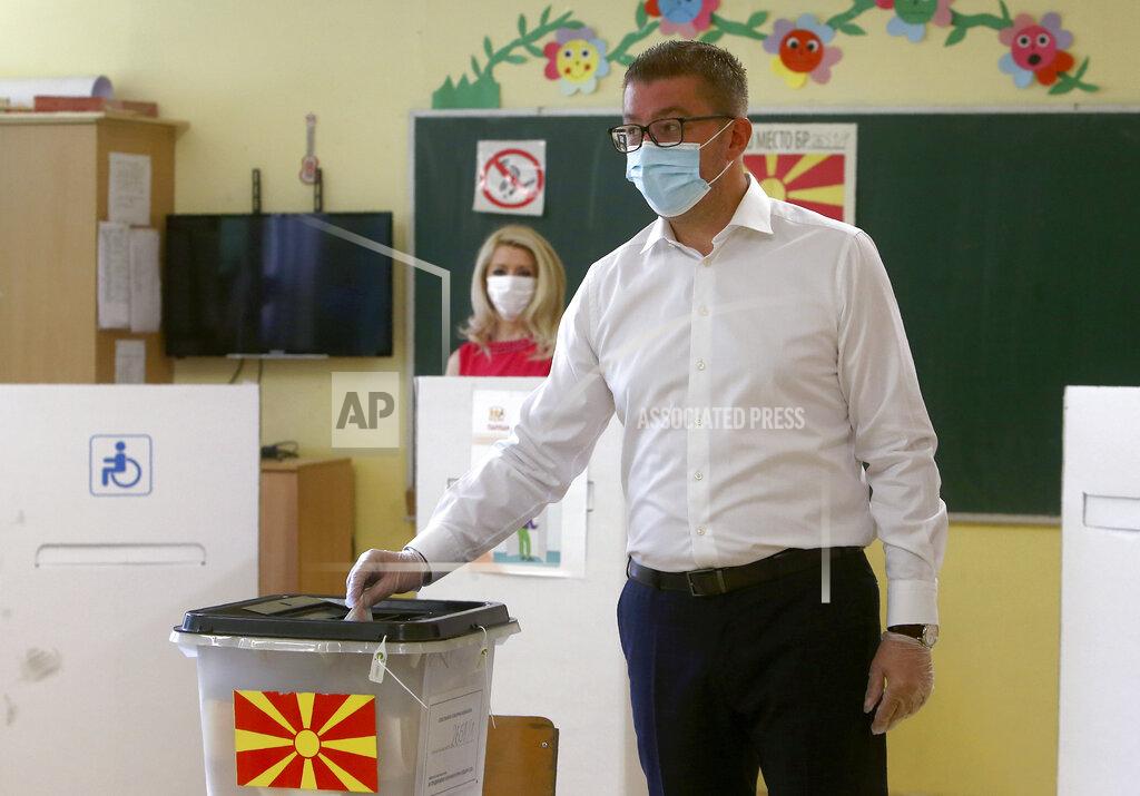 Boris Grdanoski The leader of the opposition VMRO DPMNE party Hristijan Mickoski casts his ballot for the parliamentary elections, in a polling station in Skopje, North Macedonia on Wednesday, July 15, 2020. Voters in North Macedonia headed to the polls early on Wednesday in the country's general election despite an alarming spike in coronavirus cases in the tiny Balkan nation. (AP Photo/Boris Grdanoski)