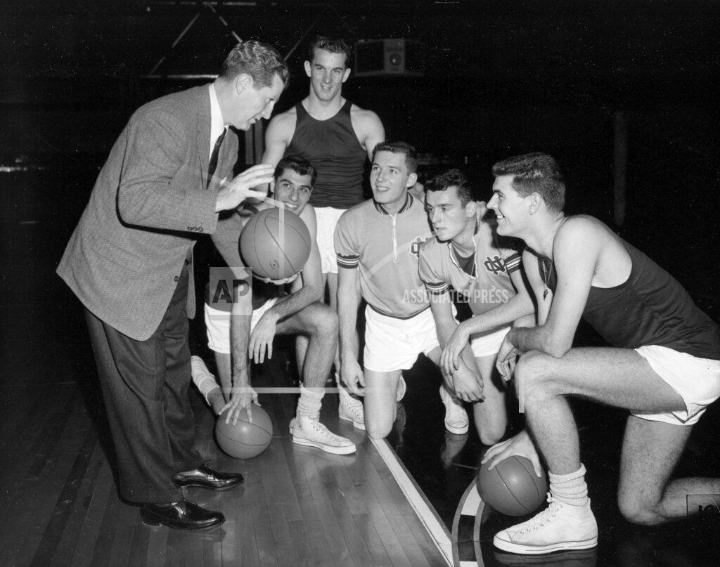 William P. Straeter FILE - North Carolina basketball coach Frank McGuire, left, gives his five starting players some pointers during a workout at Municipal Auditorium in Kansas City, Mo., in March 1957. From left are McGuire, Lennie Rosenbluth, Tom Kearns, Bob Cunningham, Pete Brennan, and Joe Quigg. Rosenbluth, who led North Carolina to its first basketball NCAA title in 1957 with a victory over Wilt Chamberlain and Kansas in the championship game, died Saturday, June 18, 2022. He was 89. (AP Photo/William P. Straeter, File)
