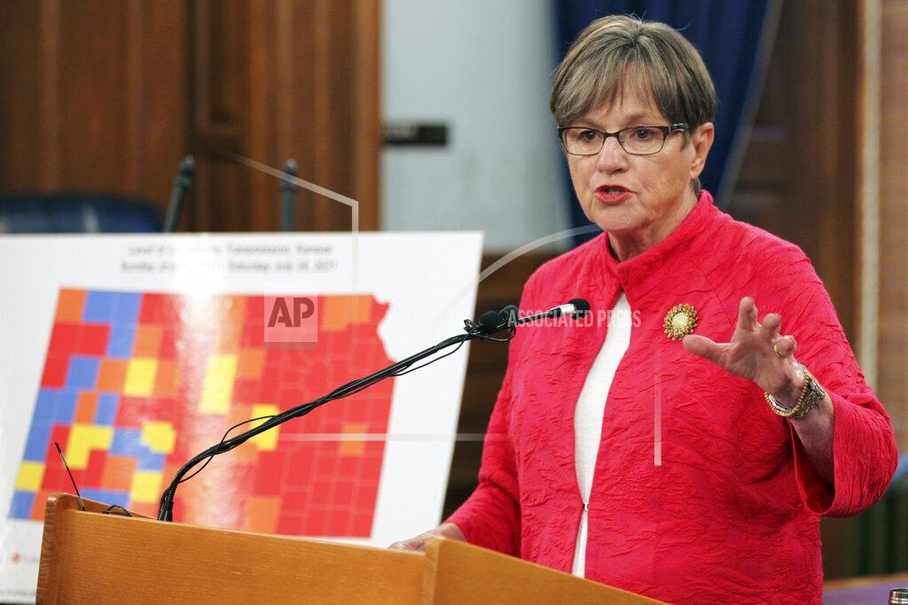 John Hanna Kansas Gov. Laura Kelly announces that she's imposing a mask mandate for state government workers and visitors to many state buildings, speaking at a news conference, Wednesday, July 28, 2021, at the Statehouse in Topeka, Kan. The large map next to Kelly shows counties with a substantial or high spread of COVID-19 in orange or red, and they are where her new mandate will apply. (AP Photo/John Hanna)