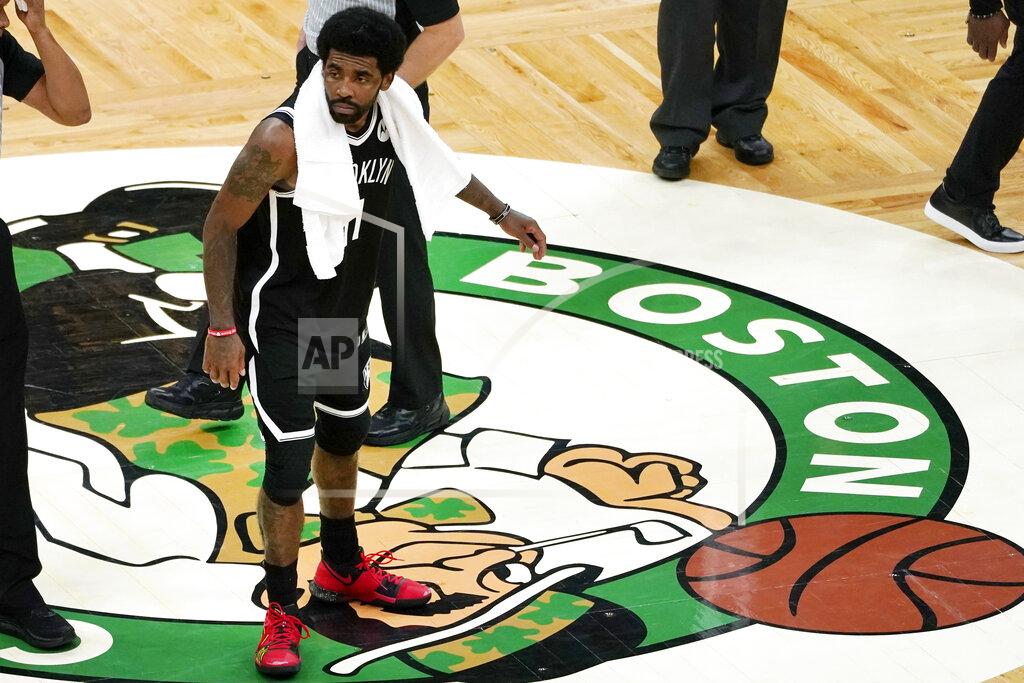Elise Amendola Brooklyn Nets guard Kyrie Irving scrapes his foot on the Boston Celtics logo at mid-court after they defeated the Celtics in Game 4 during an NBA basketball first-round playoff series, Sunday, May 30, 2021, in Boston. (AP Photo/Elise Amendola)
