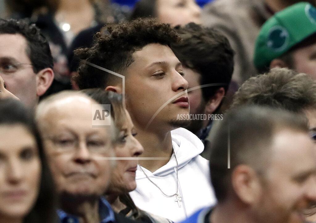 Tony Gutierrez Kansas City Chiefs quarterback Patrick Mahomes, center, watches play between the Miami Heat and the Dallas Mavericks during an NBA basketball game in Dallas, Wednesday, Feb. 13, 2019. (AP Photo/Tony Gutierrez)