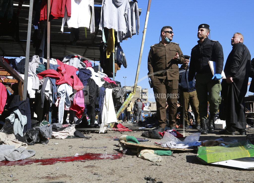Hadi Mizban Security forces work at the site of a deadly bomb attack in a market selling used clothes, Iraq, Thursday, Jan. 21, 2021. Iraq's military said twin suicide bombings have ripped through a busy market in Iraq’s capital, killing over 2 dozen and wounding over 70 with some in serious condition. (AP Photo/Hadi Mizban)