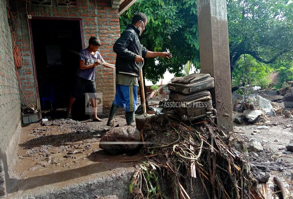 Ricko Wawo Villagers clean up mud and debris from their house following a flood in Ile Ape, on Lembata Island, East Nusa Tenggara province, Indonesia, Monday, April 5, 2021. Multiple disasters caused by torrential rains in eastern Indonesia and neighboring East Timor have left a number of people dead or missing as rescuers were hampered by damaged bridges and roads and a lack of heavy equipment Monday. (AP Photo/Ricko Wawo)