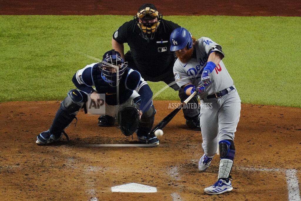 Sue Ogrocki Los Angeles Dodgers' Justin Turner hits a double against the Tampa Bay Rays during the third inning in Game 3 of the baseball World Series Friday, Oct. 23, 2020, in Arlington, Texas. (AP Photo/Sue Ogrocki)