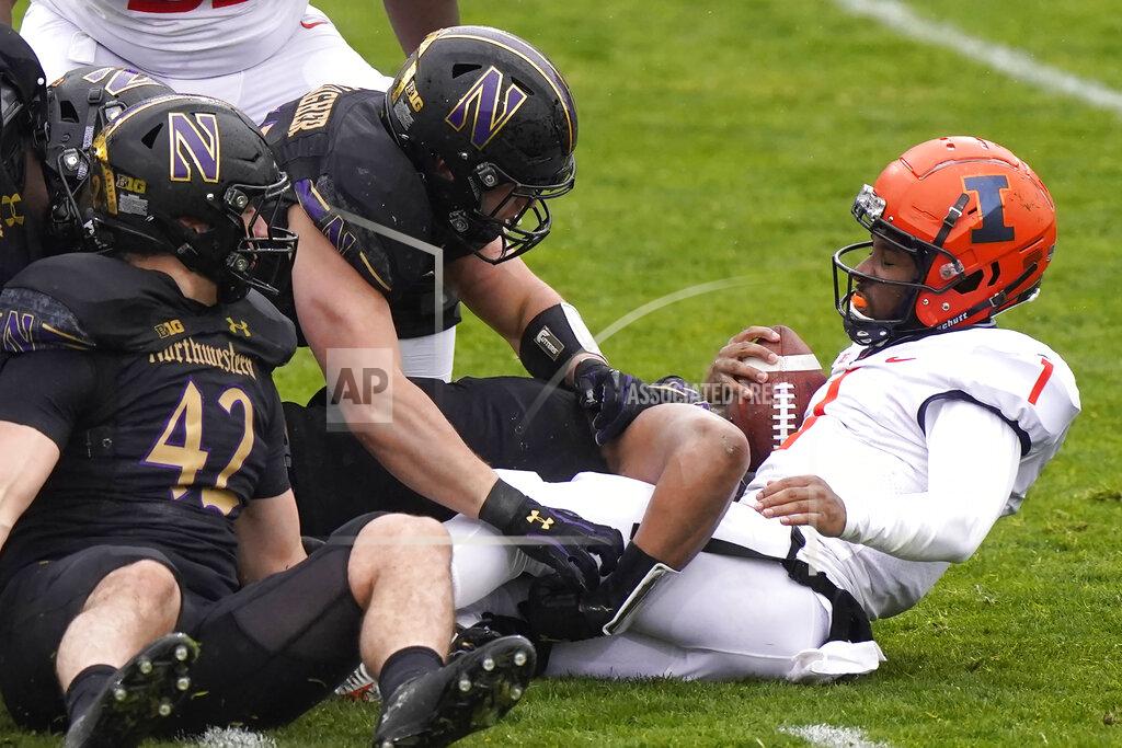 Nam Y. Huh Illinois quarterback Isaiah Williams, right, is tackled by Northwestern defenders during the first half of an NCAA college basketball game in Evanston, Ill., Saturday, Dec. 12, 2020. (AP Photo/Nam Y. Huh)
