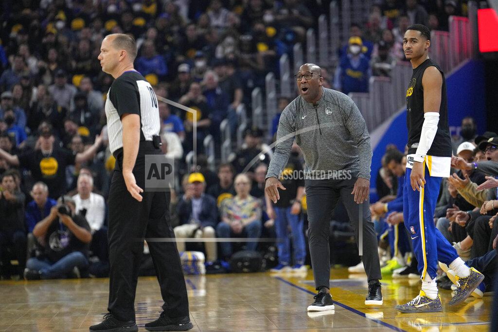 Tony Avelar Golden State Warriors assistant coach Mike Brown, center, argues with the referee, left, as Warriors guard Jordan Poole, right, looks on during the first half of Game 4 of an NBA basketball Western Conference playoff semifinal against the Memphis Grizzlies in San Francisco, Monday, May 9, 2022. Brown is filling in for head coach Steve Kerr who tested positive for COVID-19. (AP Photo/Tony Avelar)
