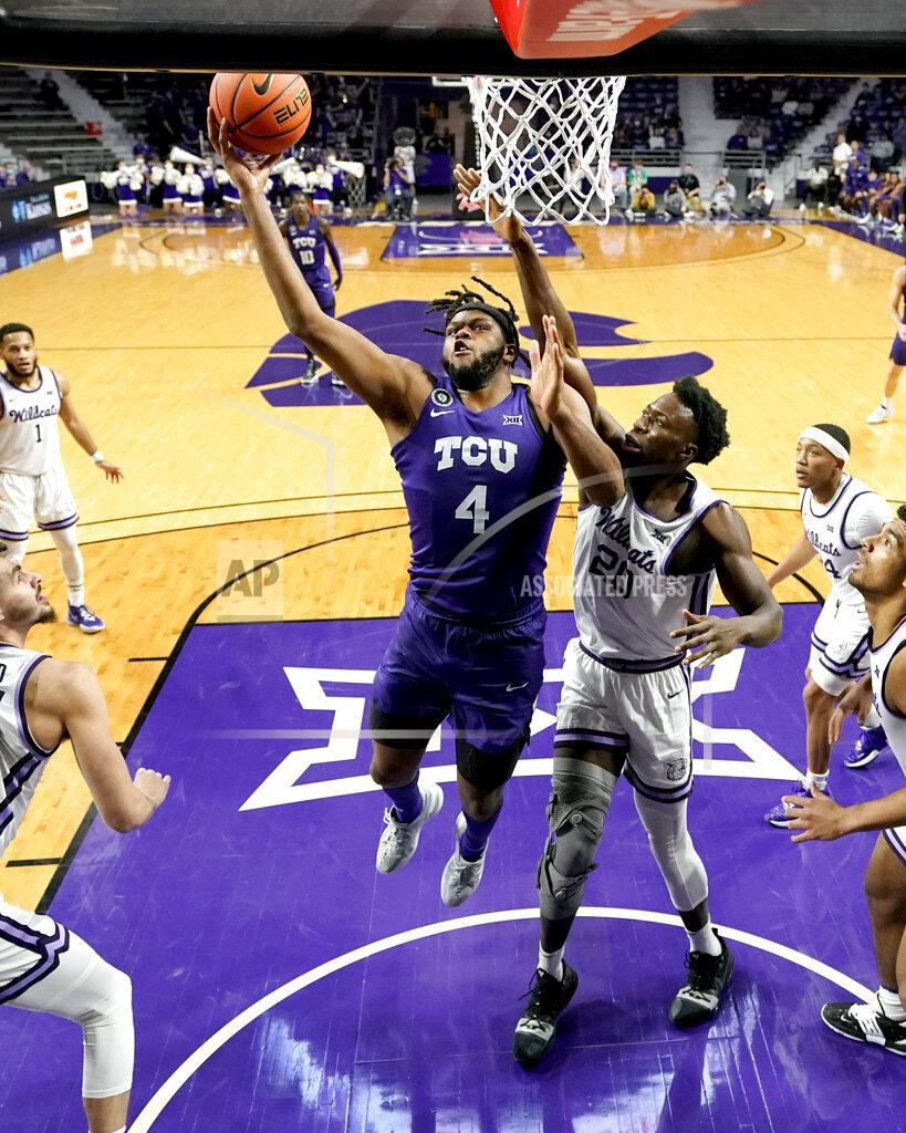 Charlie Riedel TCU center Eddie Lampkin (4) gets past Kansas State forward Kaosi Ezeagu (20) to put up a shot during the first half of an NCAA college basketball game Wednesday, Jan. 12, 2022, in Manhattan, Kan. (AP Photo/Charlie Riedel)