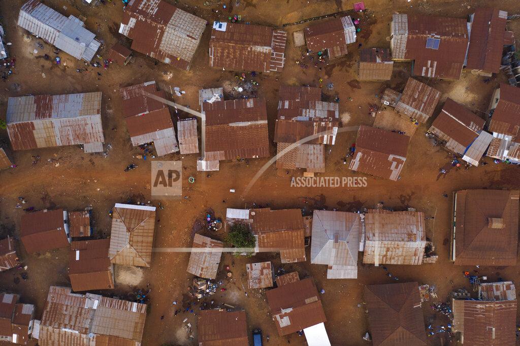 Leo Correa This Sunday, Nov. 22, 2020 photo shows homes in Komao village, on the outskirts of Koidu, district of Kono, Sierra Leone. Sierra Leone closed its borders before the country had its first COVID-19 case. As a result, the country has seen only 2,434 confirmed cases and 74 deaths. Only 76 of those cases were confirmed in Kono district, but the economic toll here has brought many families already living on the edge to a breaking point. (AP Photo/Leo Correa)