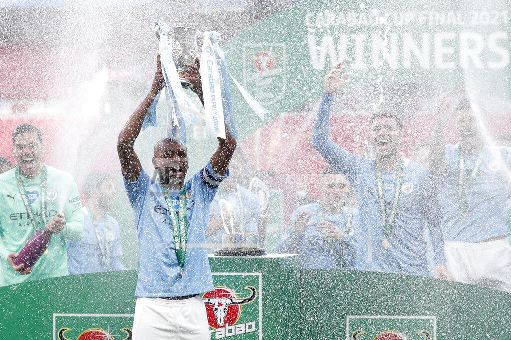 Alastair Grant Manchester City's team captain Fernandinho lifts the trophy at the end of the English League Cup final soccer match between Manchester City and Tottenham Hotspur at Wembley stadium in London, Sunday, April 25, 2021. Manchester City won 1-0. (AP Photo/Alastair Grant)