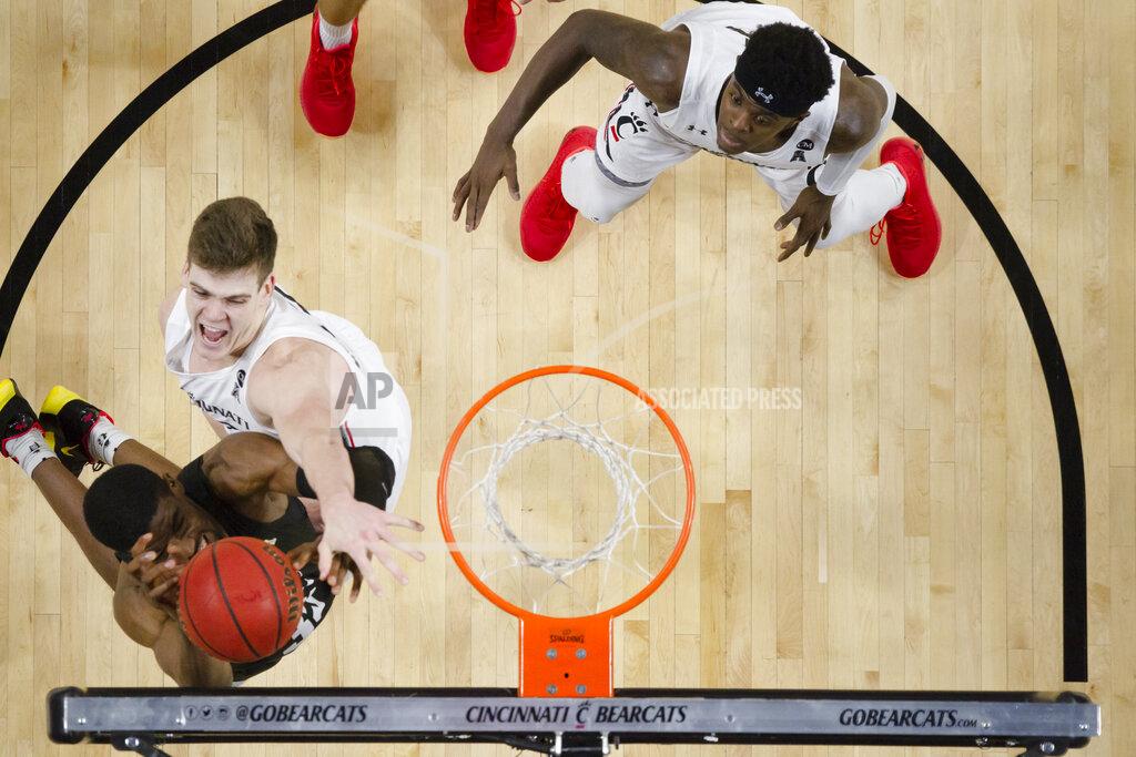 Albert Cesare Cincinnati center Chris Vogt blocks Central Florida forward Collin Smith (35) during the first overtime of an NCAA college basketball game Wednesday, Feb. 19, 2020, in Cincinnati. (Albert Cesare/The Cincinnati Enquirer via AP)