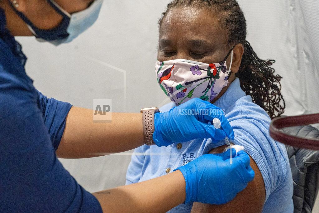 Mary Altaffer Dorrit Crawford, of Brooklyn, receives the first dose of the coronavirus vaccine at a pop-up COVID-19 vaccination site at the God's Battalion of Prayer Church, Wednesday, Feb. 3, 2021, in the Brooklyn borough of New York. SOMOS and Elderplan volunteer nurses are expected to vaccinate up to 500 older New Yorkers who attend the church or live in surrounding areas. (AP Photo/Mary Altaffer)