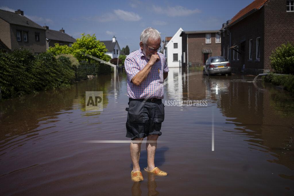 Bram Janssen FILE - In this Saturday, July 17, 2021 file photo, Wiel de Bie, 75, stands outside his flooded home in the town of Brommelen, Netherlands. Scientists say there’s something different this year from the recent drumbeat of climate weirdness. This summer a lot of the places hit by weather disasters are not used to getting extremes and many of them are wealthier, which is different from the normal climate change victims. That includes unprecedented deadly flooding in Germany and Belgium, 116-degree heat records in Portland, Oregon and similar blistering temperatures in Canada, along with wildfires. Now Southern Europe is seeing scorching temperatures and out-of-control blazes too. And the summer of extremes is only getting started. Peak Atlantic hurricane and wildfire seasons in the United States are knocking at the door. (AP Photo/Bram Janssen, File)