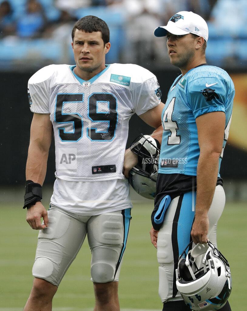Chuck Burton Carolina Panthers' Luke Kuechly (59) and JJ Jansen (44) watch players warm up during a Fan Fest practice at the NFL football team's training camp in Charlotte, N.C., Friday, Aug. 2, 2019. (AP Photo/Chuck Burton)