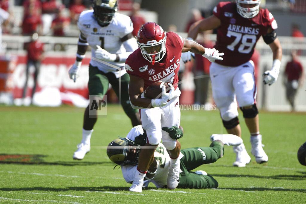 Arkansas running back Rakeem Boyd tries to get past Colorado State defender Tron Folsom during the first half of an NCAA college football game Saturday, Sept. 14, 2019 in Fayetteville, Ark. (AP Photo/Michael Woods)