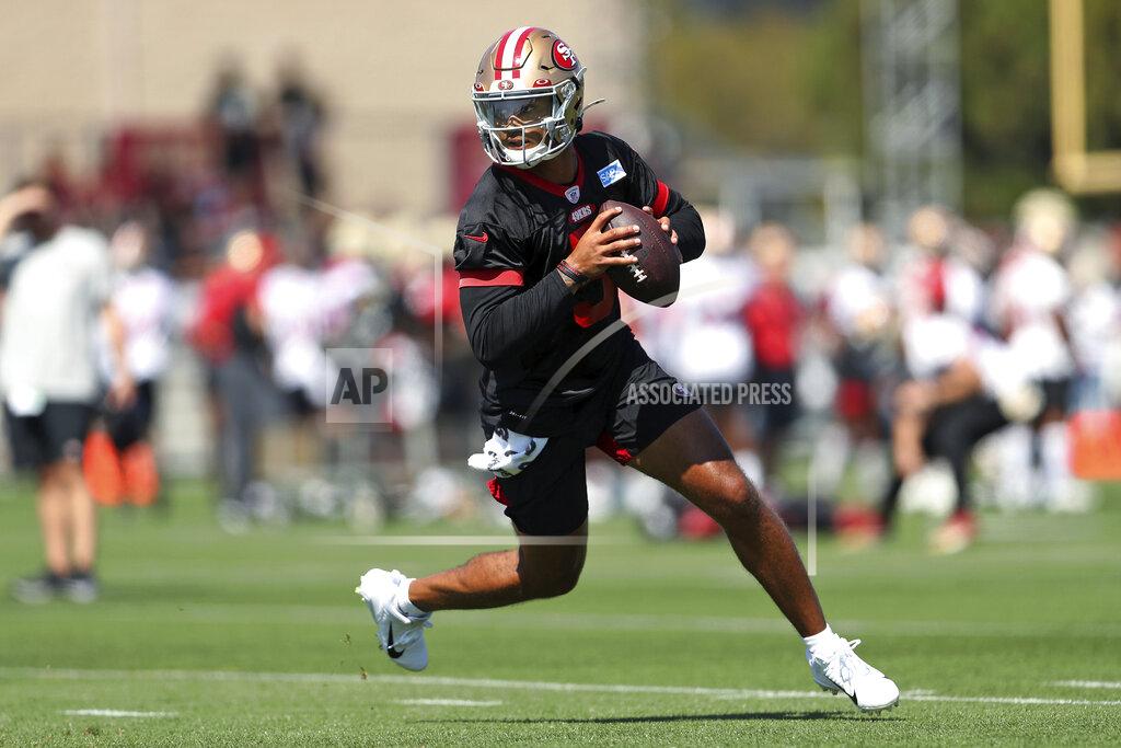 Scott Strazzante San Francisco 49ers' quarterback Trey Lance rolls out during the NFL football team's training camp in Santa Clara, Calif., Wednesday, July 27, 2022. (Scott Strazzante/San Francisco Chronicle via AP)