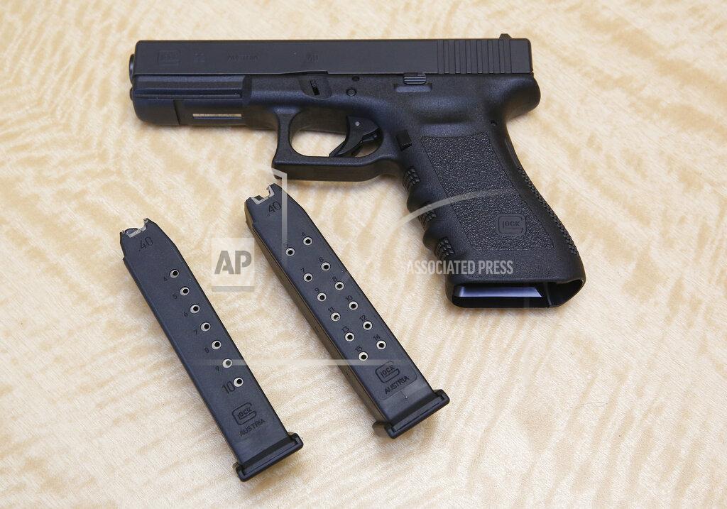 Rich Pedroncelli FILE - In this June 27, 2017, file photo, a semi-automatic hand gun is displayed with a 10 shot magazine, left, and a 15 shot magazine, right, at a gun store in Elk Grove, Calif. With Democrats controlling the presidency and Congress, Republican state lawmakers concerned about the possibility of new federal gun control laws aren't waiting to react. Legislation in at least a dozen states seeks to nullify any new restrictions, such as ammunition limits or a ban on certain types of weapons. (AP Photo/Rich Pedroncelli, File)