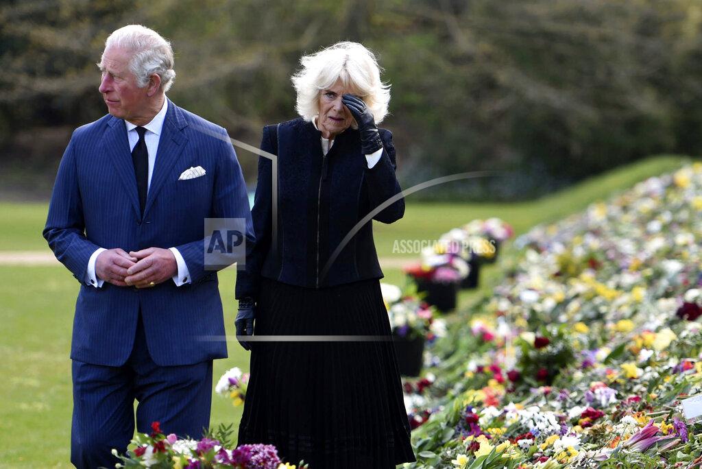 Jeremy Selwyn Britain's Prince Charles and Camilla, Duchess of Cornwall visit the gardens of Marlborough House, London, Thursday April 15, 2021, to look at the flowers and messages left by members of the public outside Buckingham Palace, following the death of Prince Philip. (Jeremy Selwyn/Pool via AP)