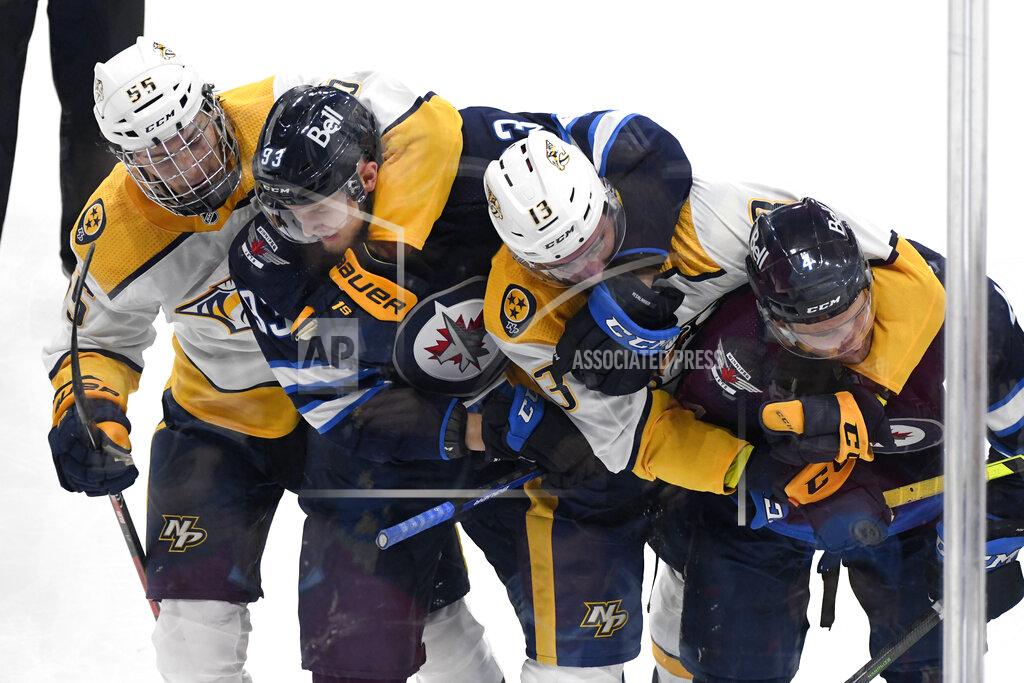 Fred Greenslade Winnipeg Jets' Kristian Vesalainen (93) and Neal Pionk (4) battle with Nashville Predators' Philippe Myers (55) and Yakov Trenin (13) during the second period of NHL hockey game action in Winnipeg, Manitoba, Saturday, Oct. 23, 2021. (Fred Greenslade/The Canadian Press via AP)