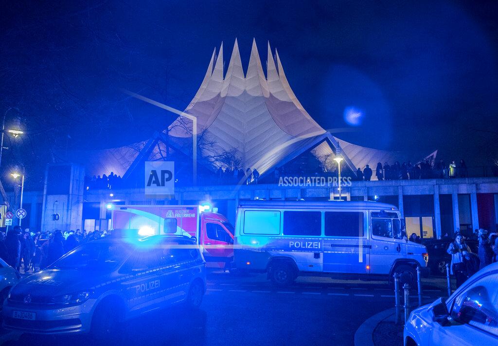 Police and emergency cars stand in front of the Tempodrom venue after a shooting in Berlin, Germany, early Saturday, Feb. 15, 2020. According to police one person was killed. (Paul Zinken/dpa via AP)