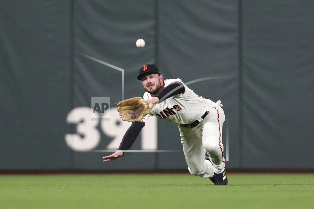 Jed Jacobsohn San Francisco Giants center fielder Kris Bryant catches a fly out hit by Los Angeles Dodgers' Trea Turner during the seventh inning of Game 2 of a baseball National League Division Series Saturday, Oct. 9, 2021, in San Francisco. (AP Photo/Jed Jacobsohn)