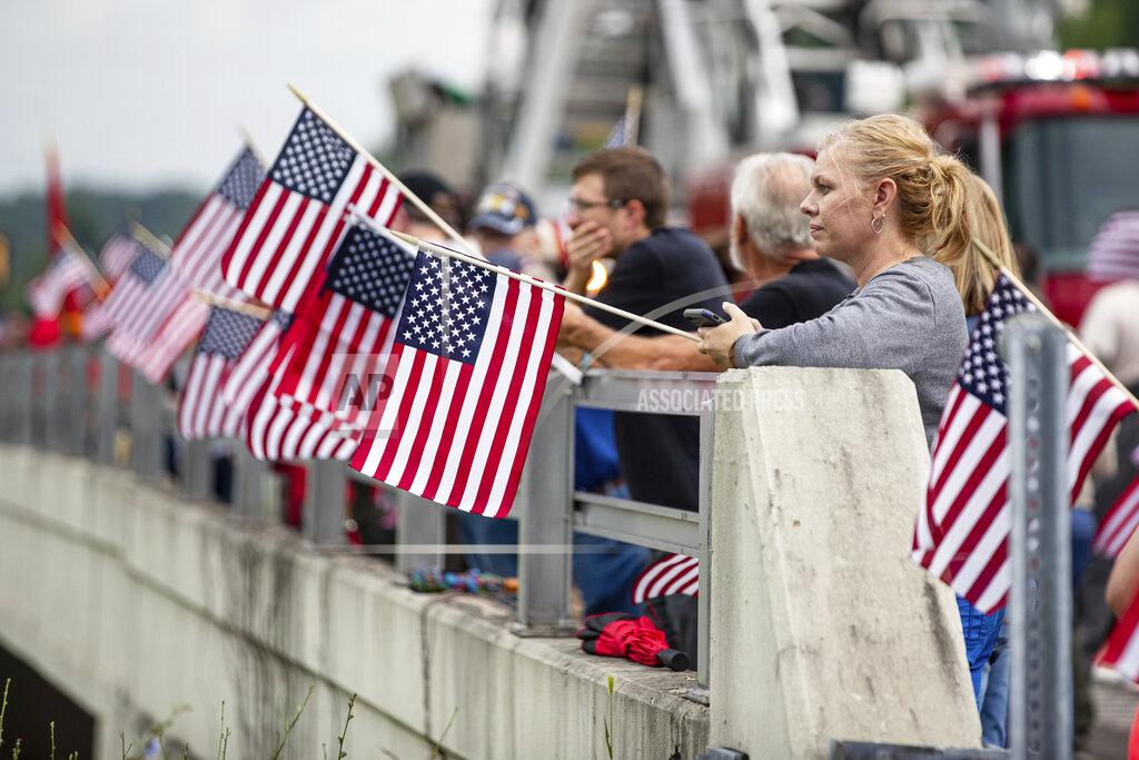 Sholten Singer Area residents arrive to show their respect before the funeral procession for Medal of Honor recipient Hershel "Woody" Williams passes by on Saturday, July 2, 2022, in Teays Valley, W.Va. (Sholten Singer/The Herald-Dispatch via AP)