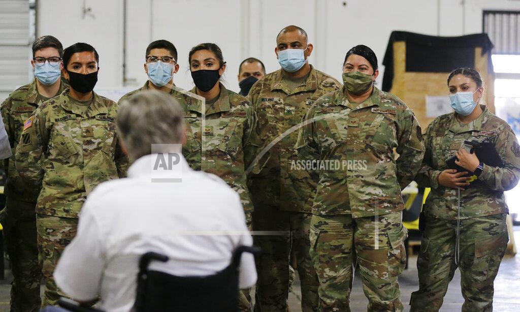 Eric Gay Texas Gov. Greg Abbott, foreground, addresses members of the National Guard during a visit to a Texas Division of Emergency Management Warehouse filled with Personal Protective Equipment, Tuesday, Aug. 4, 2020, in San Antonio. (AP Photo/Eric Gay)