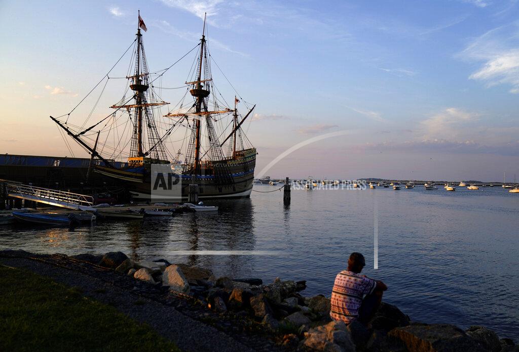 The Mayflower II, a replica of the original Mayflower ship that brought the Pilgrims to America 400 year ago, is docked in Plymouth, Mass., days after returning home following extensive renovations, Wednesday, Aug. 12, 2020. A disease outbreak that wiped out large numbers of the Native inhabitants of what is now New England gave the Pilgrims a beachhead in the "New World." So, some historians find it ironic that a pandemic has put many of the 400th anniversary commemorations of the Mayflower's landing on hold. (AP Photo/David Goldman)