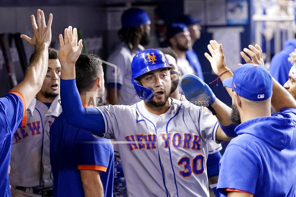 Lynne Sladky New York Mets' Michael Conforto is congratulated in the dugout after scoring on a passed ball by Miami Marlins catcher Alex Jackson during the eighth inning of a baseball game, Wednesday, Aug. 4, 2021, in Miami. The Mets won 5-3. (AP Photo/Lynne Sladky)