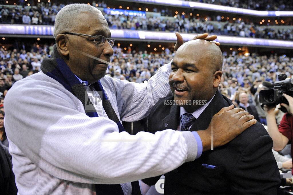 Nick Wass FILE - In this March 9, 2013, file photo, former Georgetown coach John Thompson Jr., left, congratulates his son Georgetown head coach John Thompson III, right, after the Hoya's 61-39 win over Syracuse in an NCAA college basketball game in Washington. John Thompson, the imposing Hall of Famer who turned Georgetown into a “Hoya Paranoia” powerhouse and became the first Black coach to lead a team to the NCAA men’s basketball championship, has died. He was 78 His death was announced in a family statement Monday., Aug. 31, 2020. No details were disclosed. (AP Photo/Nick Wass, File)