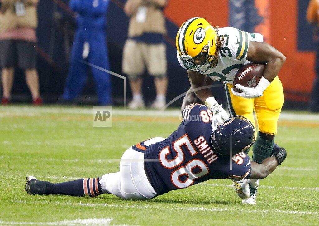 Charles Rex Arbogast Green Bay Packers' Aaron Jones is stopped by Chicago Bears' Roquan Smith during the first half of an NFL football game Thursday, Sept. 5, 2019, in Chicago. (AP Photo/Charles Rex Arbogast)