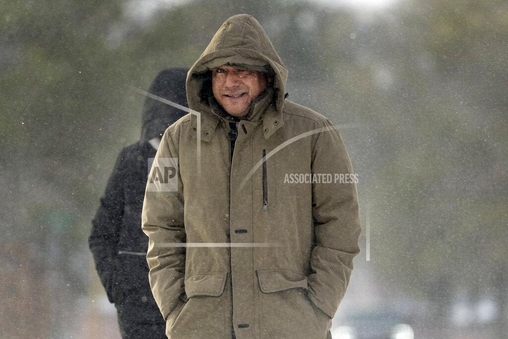 David J. Phillip Erasmo Vazquez walks through blowing snow Monday, Feb. 15, 2021, in Houston. A winter storm dropping snow and ice sent temperatures plunging across the southern Plains, prompting a power emergency in Texas a day after conditions canceled flights and impacted traffic across large swaths of the U.S. (AP Photo/David J. Phillip)