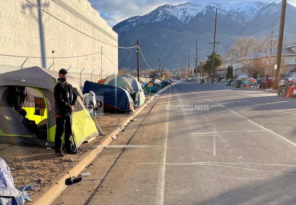 Tim Vandenack Matthew Robinson stands outside his tent at a tent city encampment along 33rd Street, Wednesday, Dec. 2, 2020, in Ogden, Utah. (Tim Vandenack/Standard-Examiner via AP)