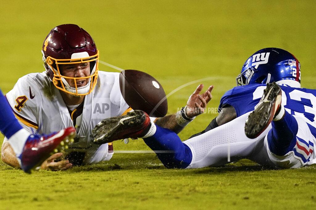 Alex Brandon Washington Football Team quarterback Taylor Heinicke (4) looses the ball against New York Giants cornerback Logan Ryan (23) during the second half of an NFL football game, Thursday, Sept. 16, 2021, in Landover, Md. (AP Photo/Alex Brandon)